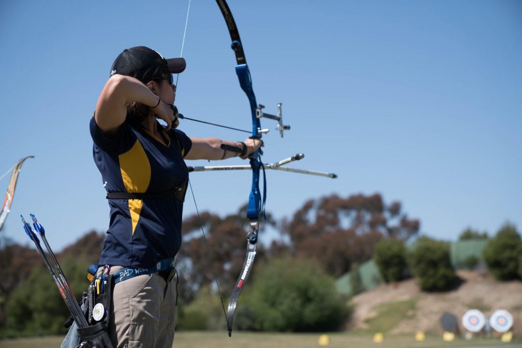 Scientist Spotlight: Eva Morozoko - image of Morozoko practicing archery