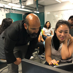 Dr. Sunil Gandhi assists student in neuroscience and behavior lab