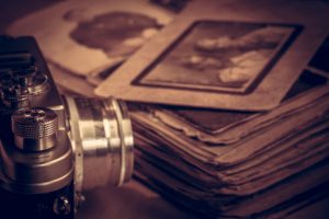 Working Memory Podcast Episode with Michael Yassa, PhD - image of A camera next to an old photo album on the table.