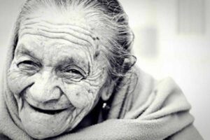 Black and white image of older woman smiling
