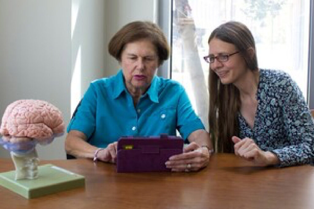 UCI Neuroscience Professor receives NIH grant to study working memory interventions in older adults - image of Susanne Jaeggi working with older adult woman