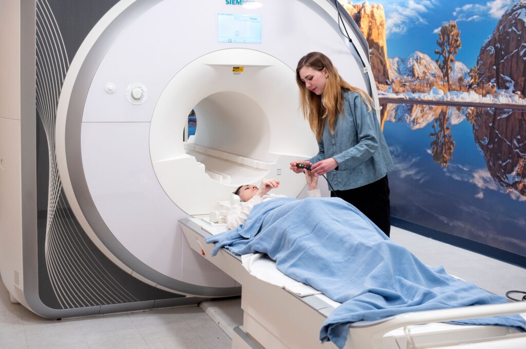 Student in MRI machine to examine brain