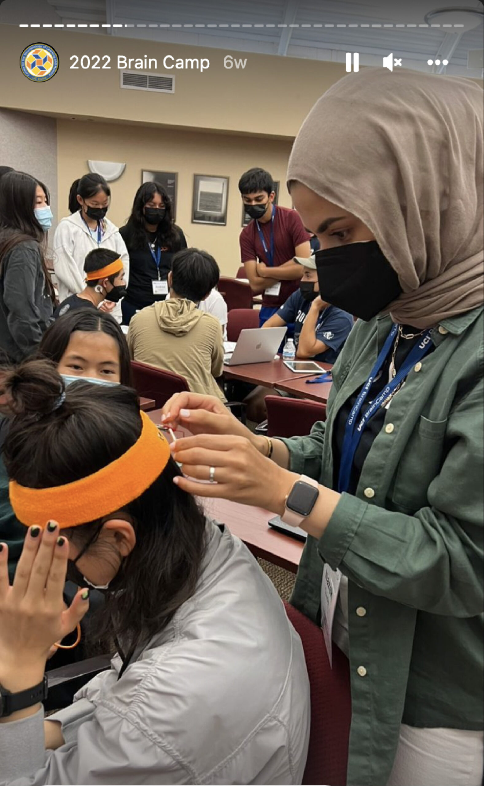 UCI Brain Camp instructor attaching electrodes