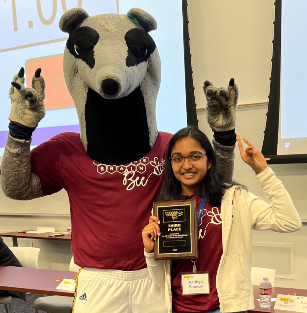 Irvine Brain Bee Student holding award with UCI Anteater Mascot