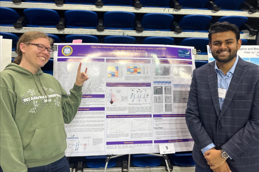 T32 Researchers standing in front of research poster - T32 Updates 2023
