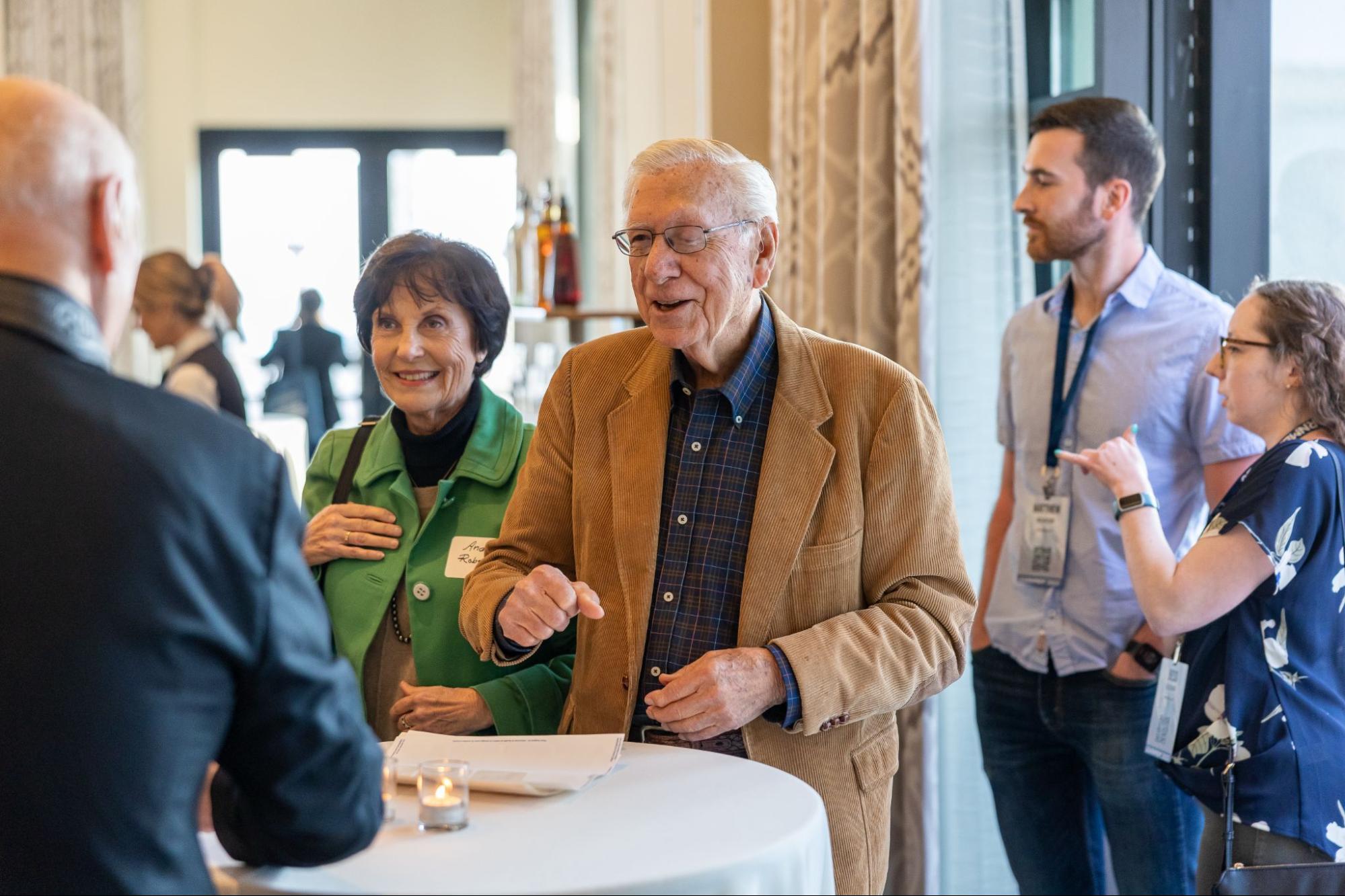 CNLM Founding Director Dr. James L. McGaugh laughs with 
conference attendees at a special 40th Anniversary celebration event during LEARNMEM2023.