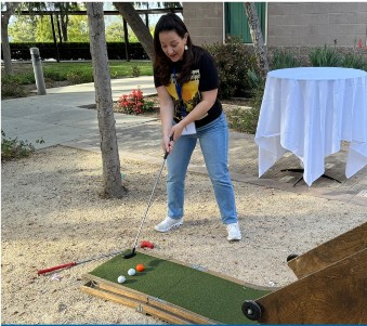 CNLM Director of Outreach and Education Dr. Manuella Oliveira Yassa plays Puttskee during the Spring Meeting BrainFest in the courtyard.