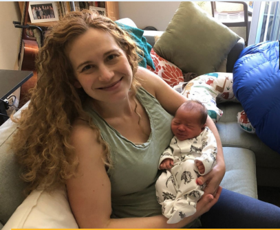 Dr. Liz Chrastil poses with her newborn baby 