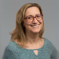 Photograph of Kristin Bass, PhD, a 50 year-old white woman with blond hair and glasses.